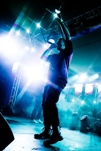 Conrad de Jager, arm raised, in blue haze
